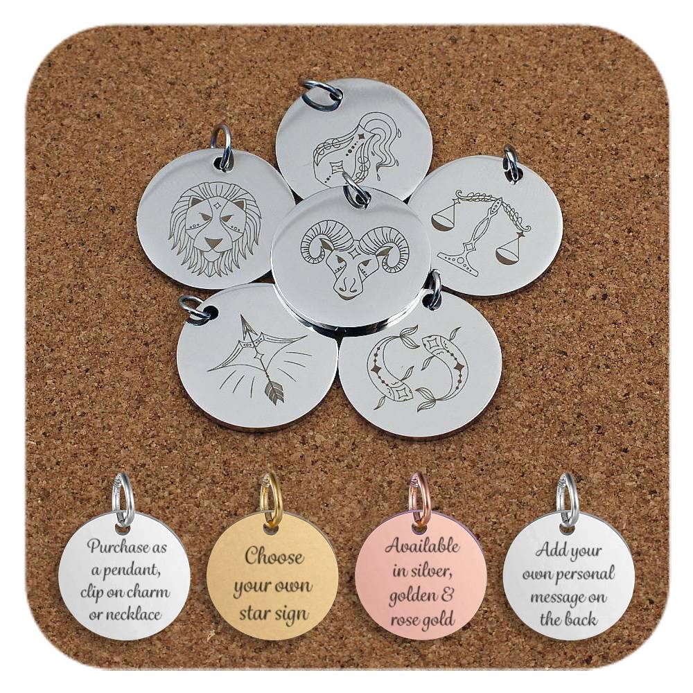 Collection of round silver metal pendants engraved with astrological zodiac symbols, displayed on a cork background. Designs include Aries, Pisces, Libra, Leo, Sagittarius, and Aquarius among others. Below the pendants are four discs engraved with the text: 'Purchase as a pendant, clip on charm or necklace,' 'Choose your own star sign', 'Available in silver, golden & rose gold' and 'Add your own personal message on the back.'