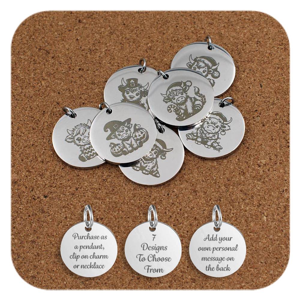 A collection of round stainless steel pendants engraved with cute Highland cow designs in various festive and seasonal themes, including Halloween, Christmas, and St. Patrick’s Day, displayed on a cork background. Below the pendants are three additional discs showing engraved text that reads: 'Purchase as a pendant, clip on charm or necklace,' '7 Designs To Choose From,' and 'Add your own personal message on the back'