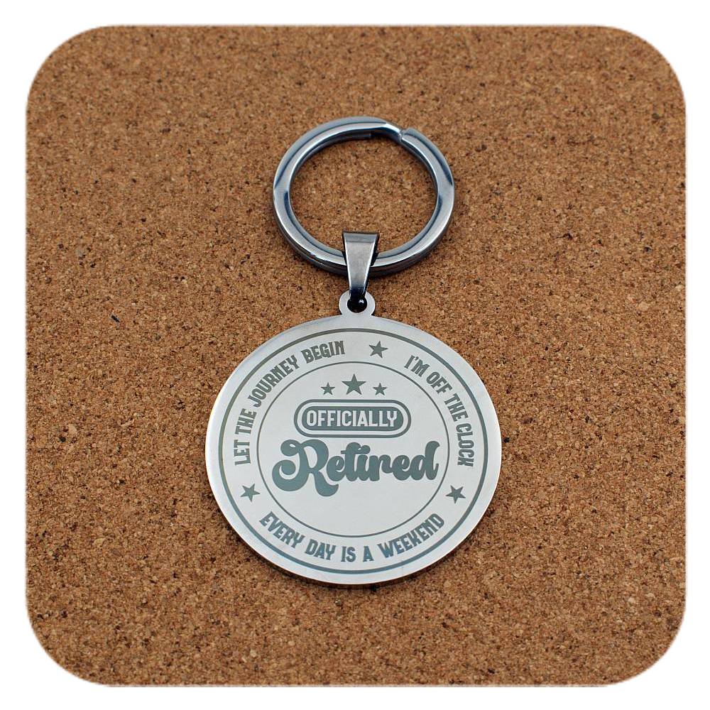 Keychain with 'Officially Retired' text on a cork background