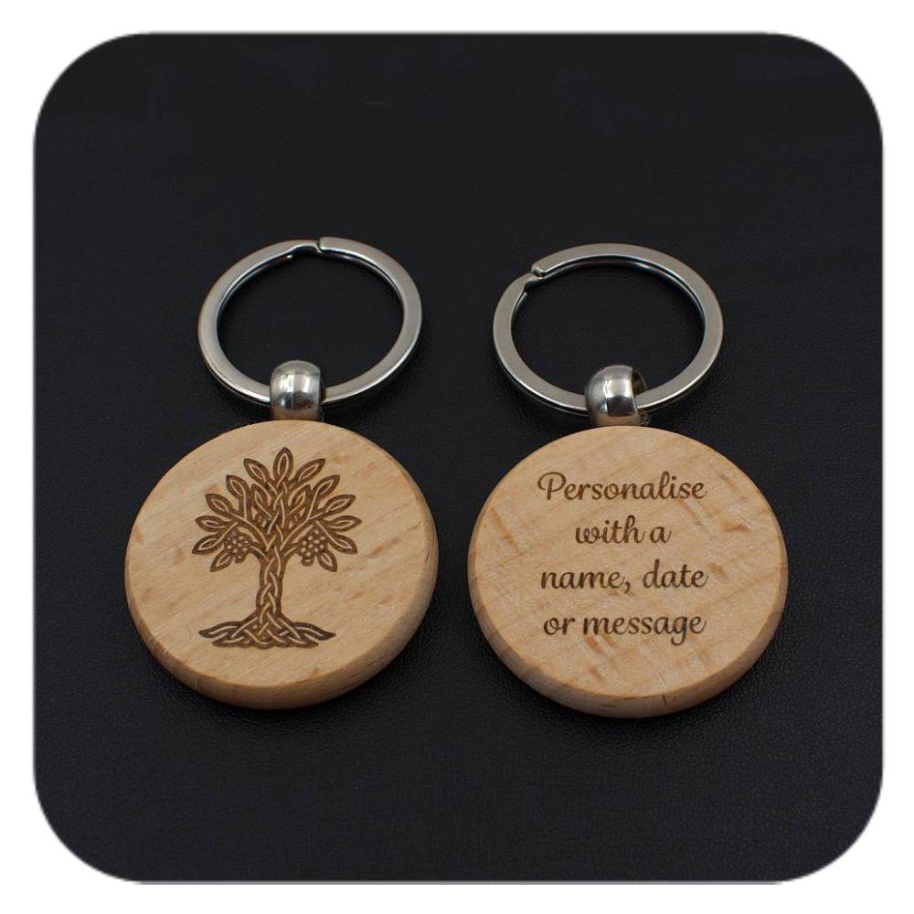 A keyring with Rowan Celtic Tree Zodiac design and another with sample wording on black background
