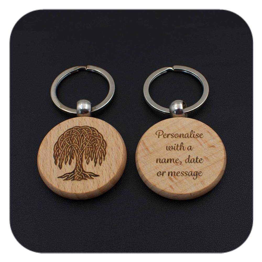 A keyring with Willow Celtic Tree Zodiac design and another with sample wording on black background