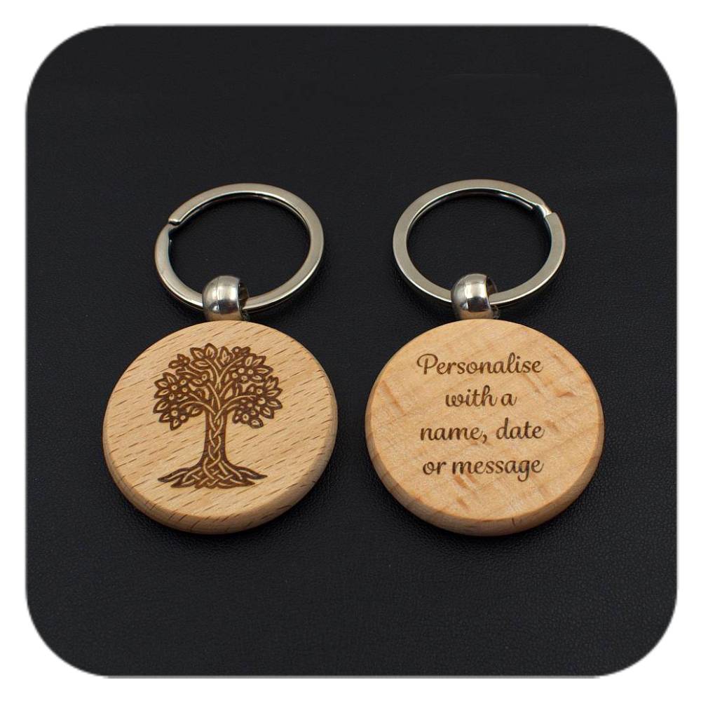 A keyring with Hazel Celtic Tree Zodiac design and another with sample wording on black background