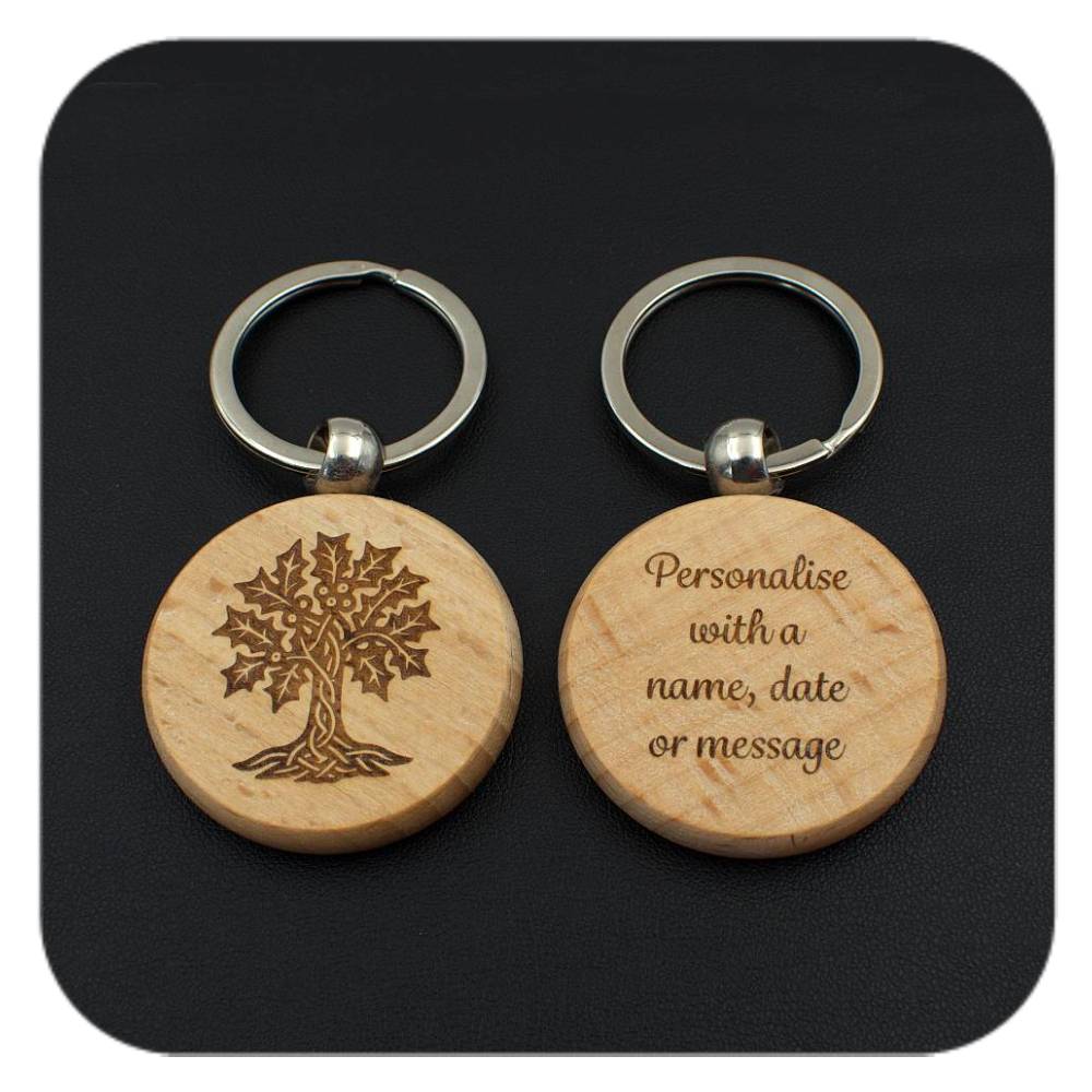 A keyring with Holly Celtic Tree Zodiac design and another with sample wording on black background