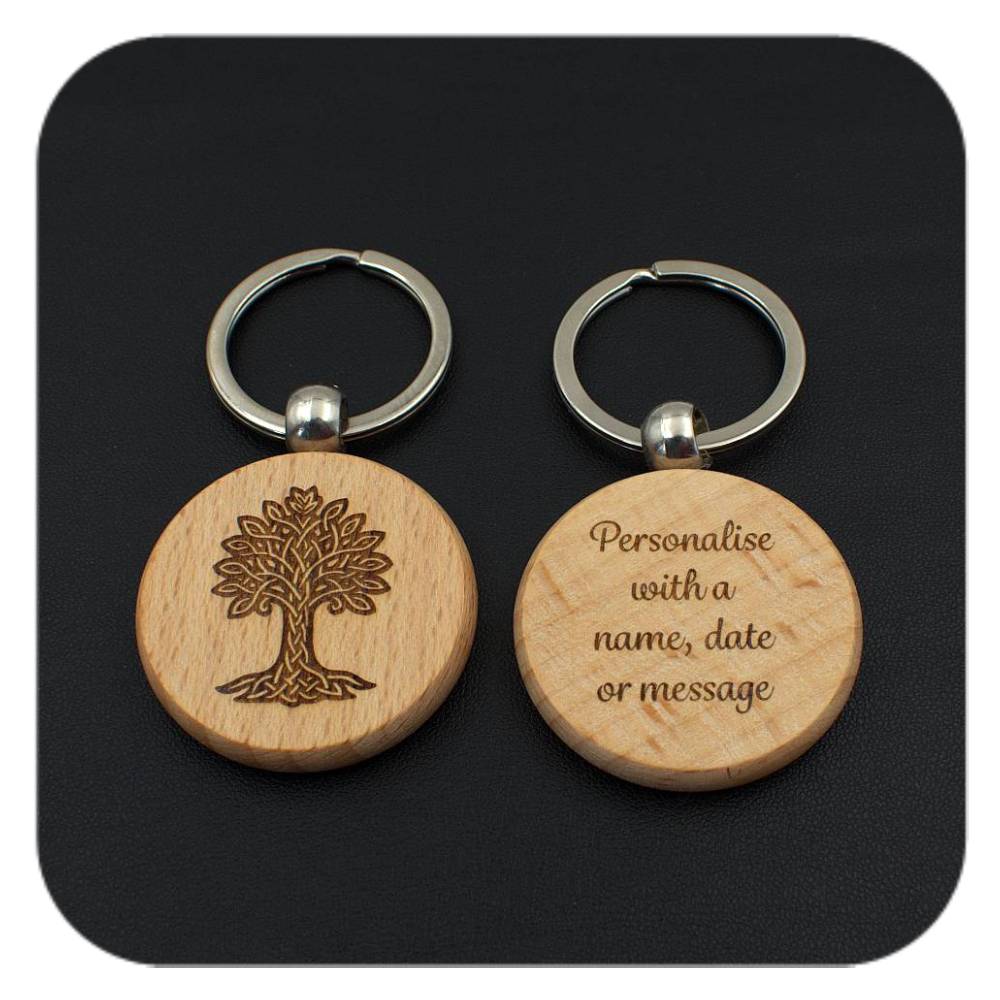 A keyring with Oak Celtic Tree Zodiac design and another with sample wording on black background