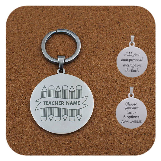 Teacher-themed keychain showing 6 crayons with a ribbon across the middle to add teachers name, on a cork display block
