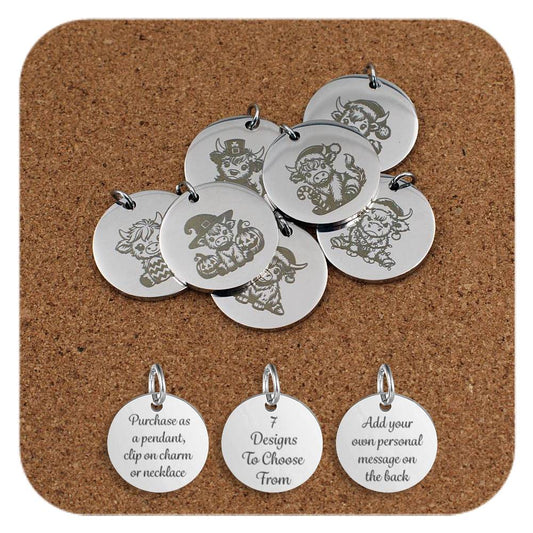 A collection of round stainless steel pendants engraved with cute Highland cow designs in various festive and seasonal themes, including Halloween, Christmas, and St. Patrick’s Day, displayed on a cork background. Below the pendants are three additional discs showing engraved text that reads: 'Purchase as a pendant, clip on charm or necklace,' '7 Designs To Choose From,' and 'Add your own personal message on the back'