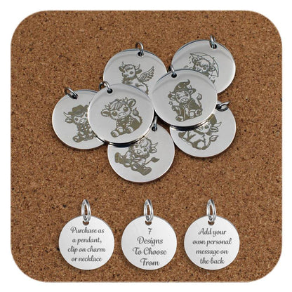 Collection of seven round silver pendants featuring engraved cartoon-style cow designs, displayed on a corkboard background. Three additional pendants at the bottom show engraved text that reads: 'Purchase as a pendant, clip on charm or necklace,' '7 Designs To Choose From,' and 'Add your own personal message on the back