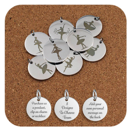 A group of stainless steel pendants engraved with elegant ballerina silhouettes in various dance poses, arranged on a cork background. Below the pendants are three additional discs showing engraved text that reads: 'Purchase as a pendant, clip on charm or necklace,' '8 Designs To Choose From,' and 'Add your own personal message on the back'