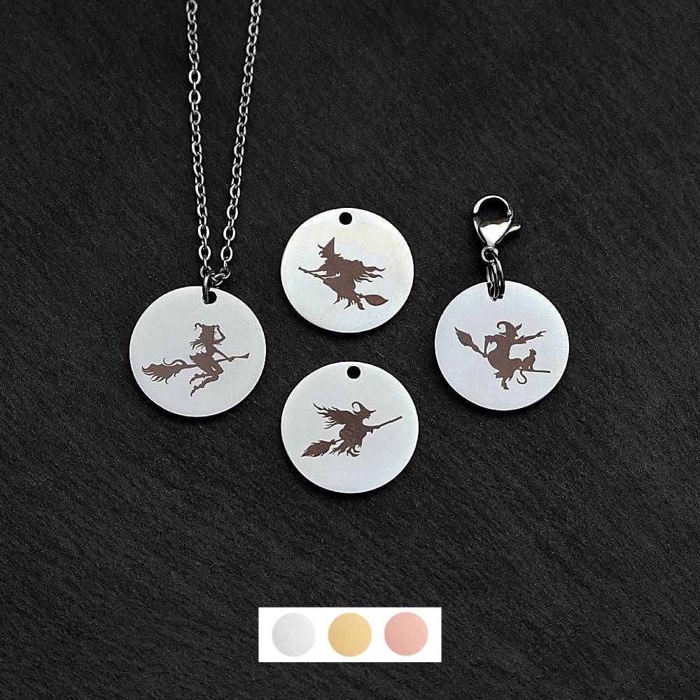 Four silver round disc pendants on a black slate background showing four different witches on a broomstick designs. One has a silver necklace attached by a jump ring and another has a lobster clasp and split ring attached to it