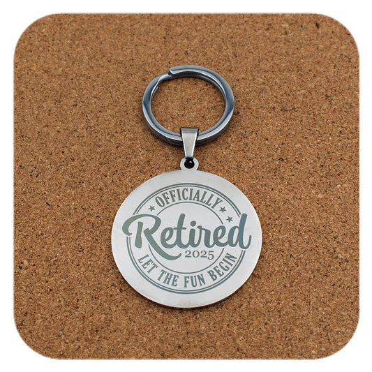Silver keyring with Retired Let The Fun Begin 2025 design on cork background