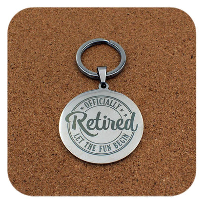 Silver keyring with Retired Let The Fun Begin design on cork background