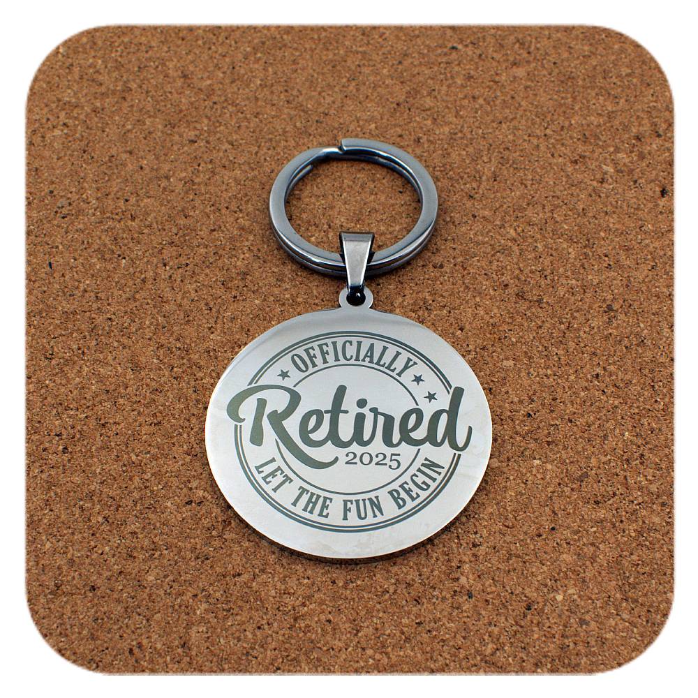 Silver keyring with Retired Let The Fun Begin 2025 design on cork 