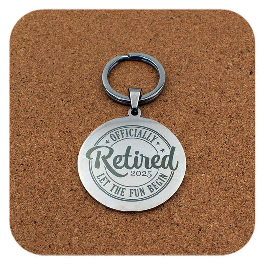 Silver keyring with Retired Let The Fun Begin 2025 design on cork 