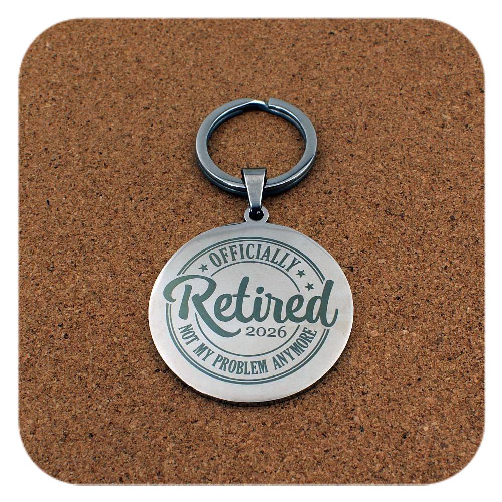 Silver keyring with Retired 2026 Not My Problem Anymore design on cork background