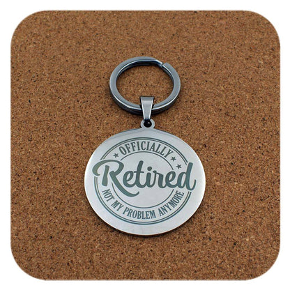 Silver keyring with Retired Not My Problem Anymore design on cork background