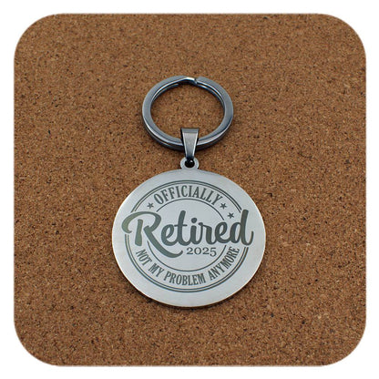 Silver keyring with Retired 2025 Not My Problem Anymore design on cork background