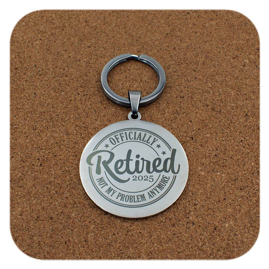 Silver keyring with Retired 2025 Not My Problem Anymore design on cork background