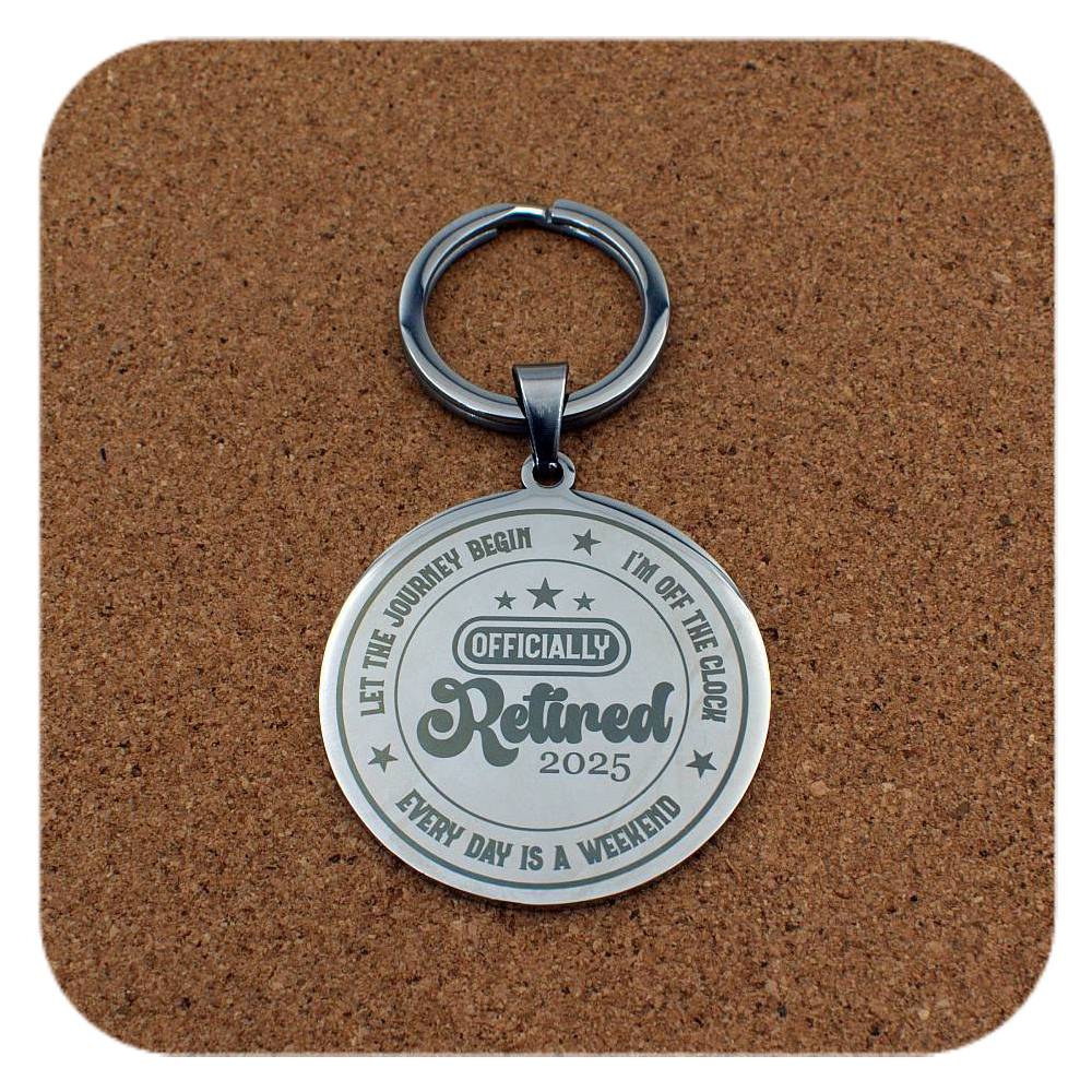 Silver keyring with Retired 2025 Every Day Is A Weekend design on cork background