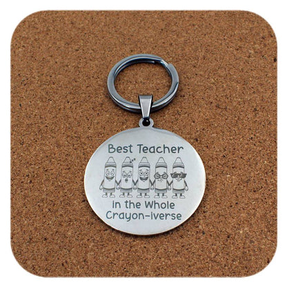 Silver keyring with Best Teacher In Crayon-iverse design on cork background