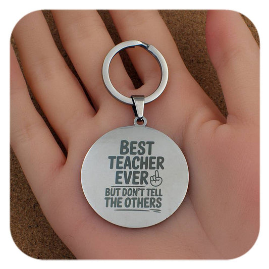 Silver keyring with Best Teacher Don't Tell Others design held in a hand