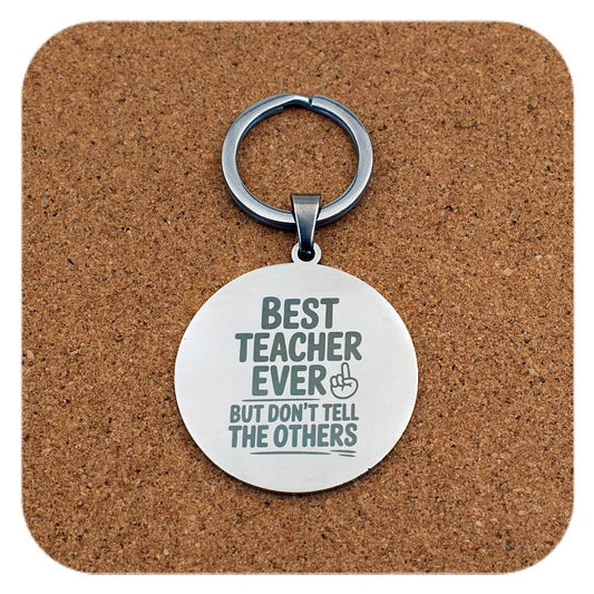 Silver keyring with Best Teacher Don't Tell Others design on cork background