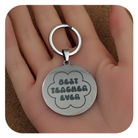 Silver keyring with Best Teacher Ever Flower design held in a hand