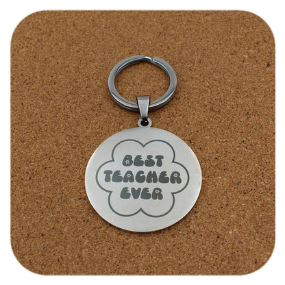 Silver keyring with Best Teacher Ever Flower design on cork background