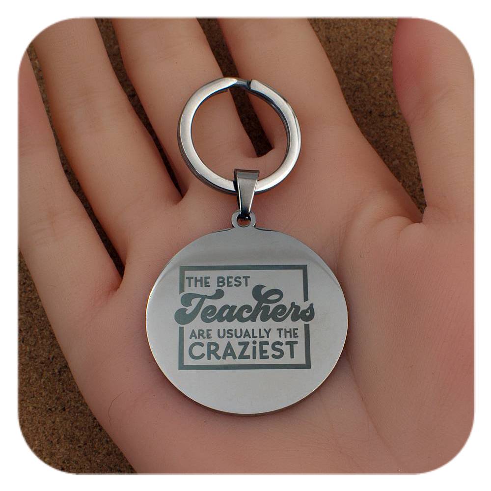 Silver keyring with Best Teachers Usually The Craziest design held in a hand