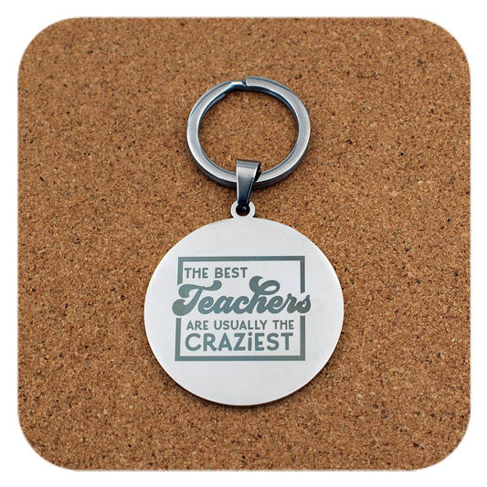 Silver keyring with Best Teachers Usually The Craziest design on cork background