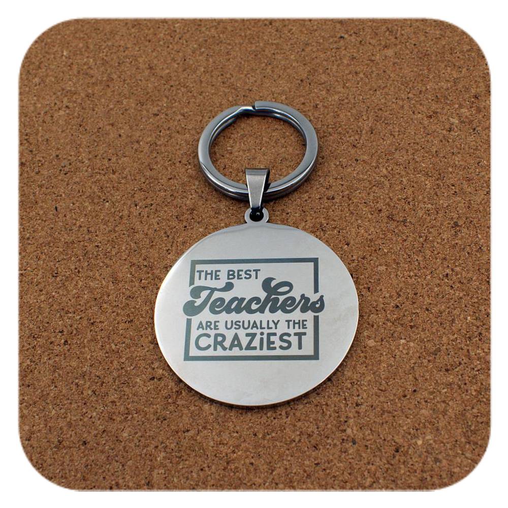 Silver keyring with Best Teachers Usually The Craziest design on cork background