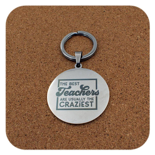 Silver keyring with Best Teachers Usually The Craziest design on cork background