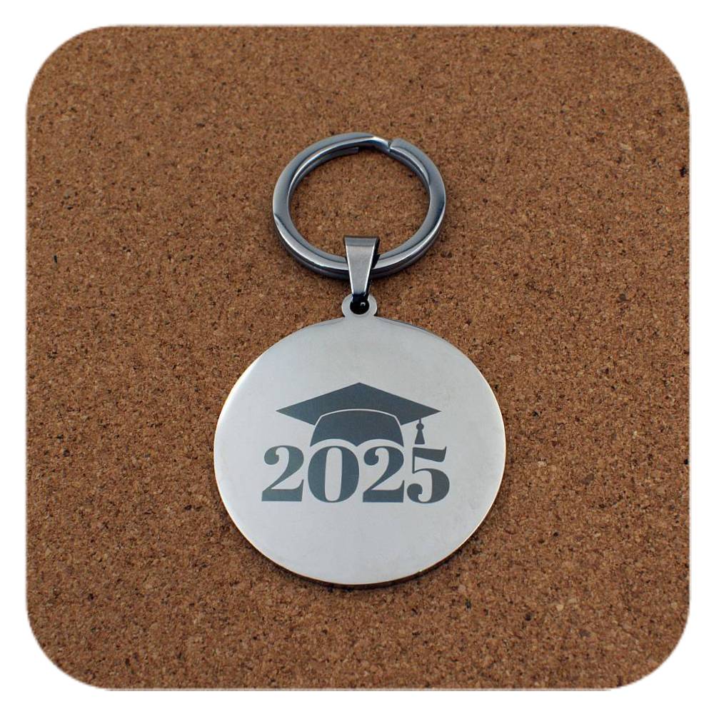 Silver keyring with Graduation Cap 2025 design on cork background