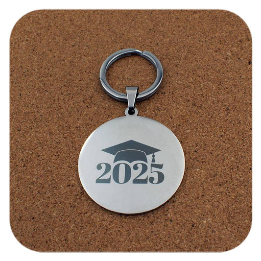 Silver keyring with Graduation Cap 2025 design on cork background