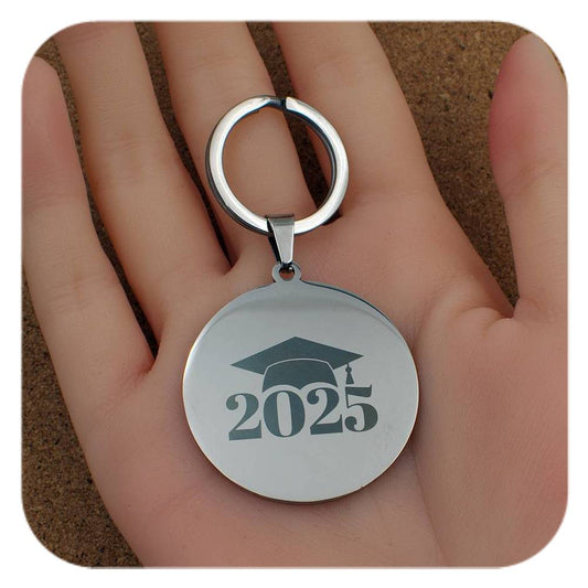 Silver keyring with Graduation Cap 2025 design held in a hand