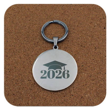 Silver keyring with Graduation Cap 2026 design on cork background