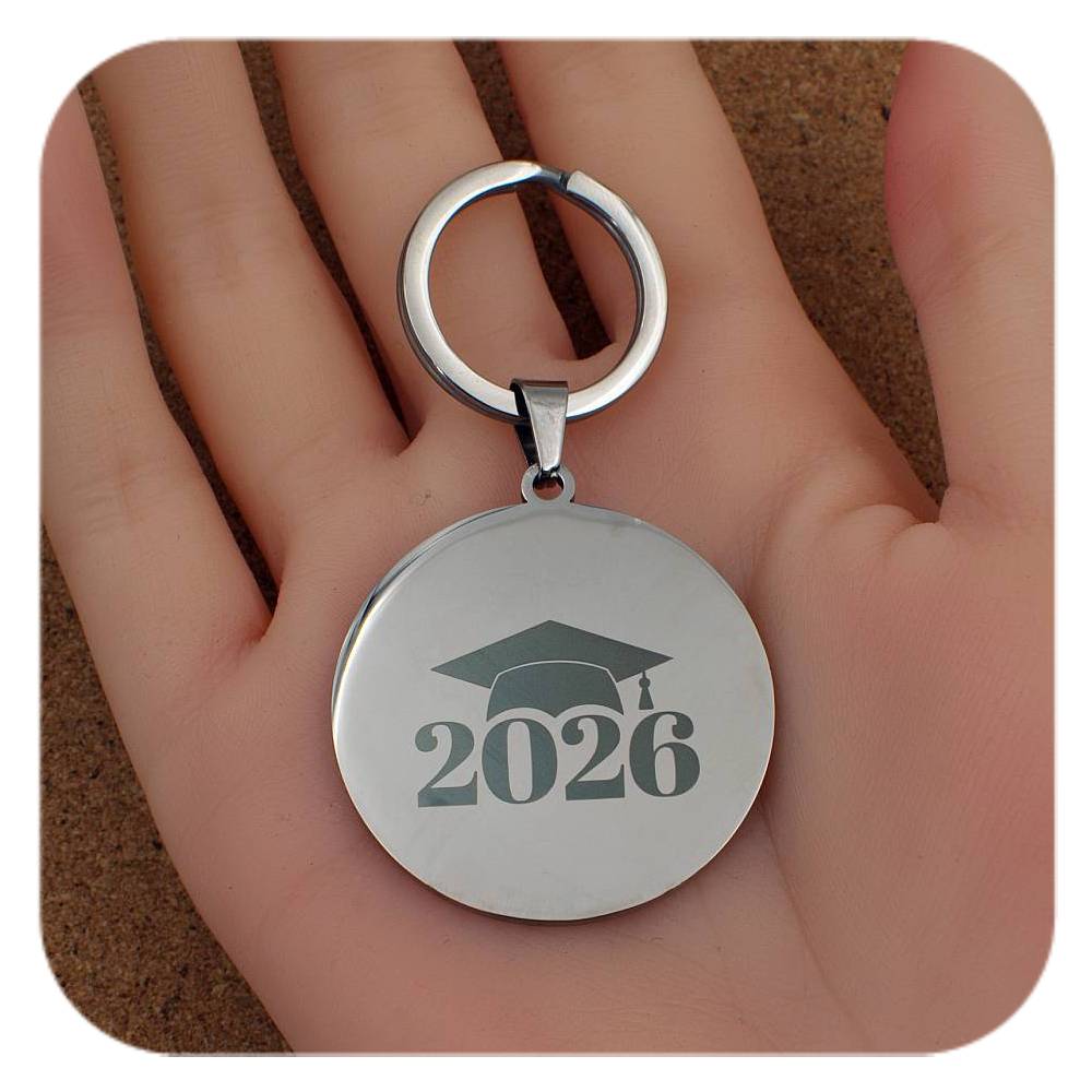Silver keyring with Graduation Cap 2026 design held in a hand