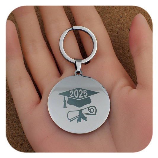 Silver keyring with Graduation Cap Diploma 2025 design held in a hand
