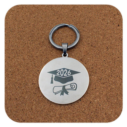 Silver keyring with Graduation Cap Diploma 2026 design on cork background