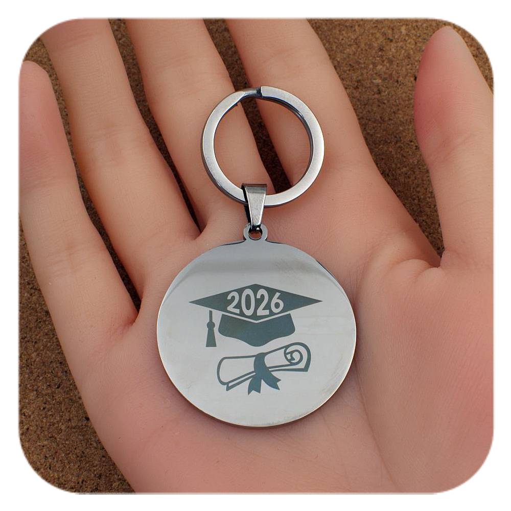 Silver keyring with Graduation Cap Diploma 2026 design held in a hand