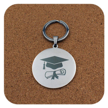 Silver keyring with Graduation Cap Diploma design on cork background