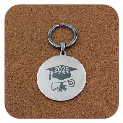 Silver keyring with Graduation Cap Diploma 2025 design on cork background