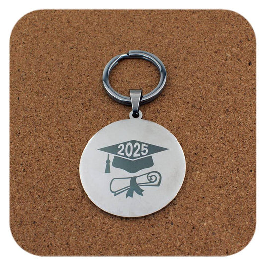 Silver keyring with Graduation Cap Diploma 2025 design on cork background