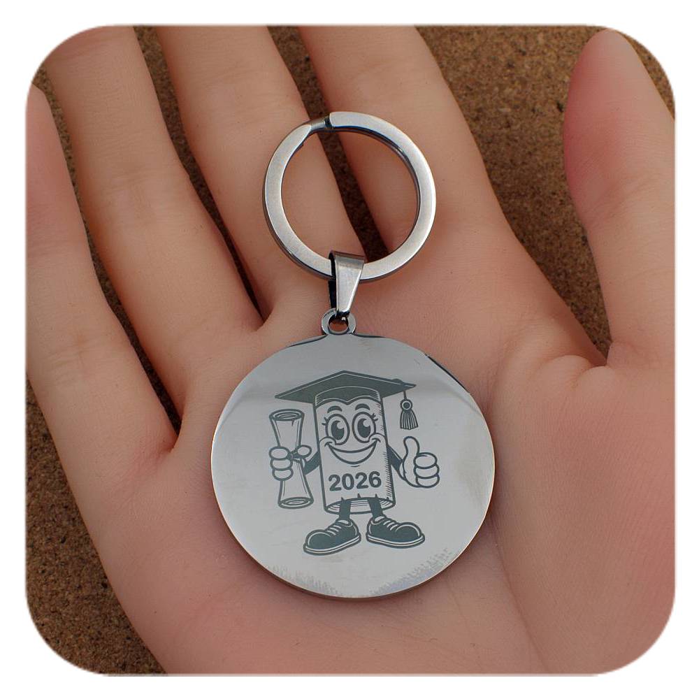 Silver keyring with Novelty Graduation Diploma design held in a hand
