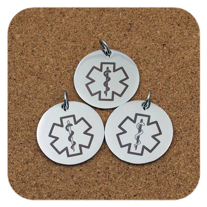 Silver pendants with different Medical Alert Star Of Life designs on cork background