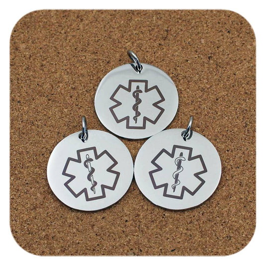 Silver pendants with different Medical Alert Star Of Life designs on cork background