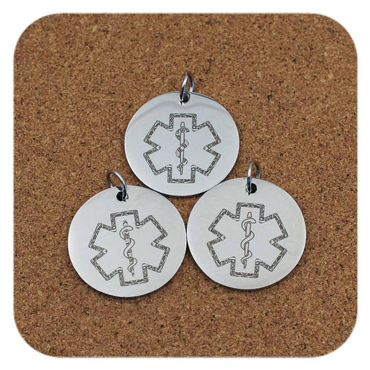 Silver pendants with different Star Of Life Symbol designs on cork background