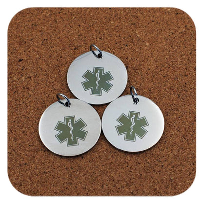 Silver pendants with different Star Of Life Medical ID designs on cork background