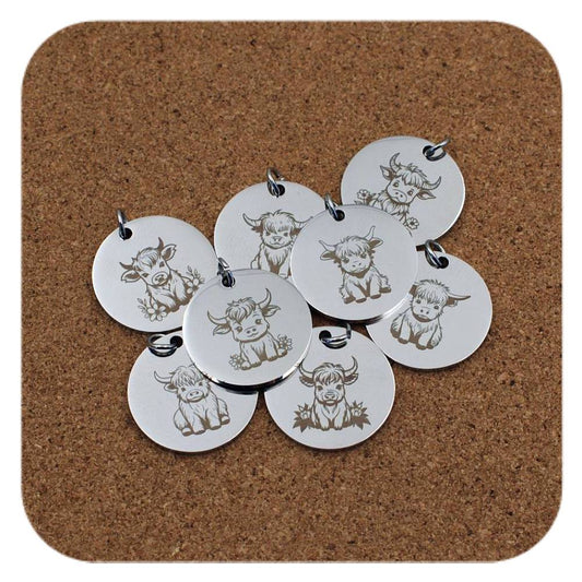 Silver pendants with different Cute Highland Cow designs on cork background