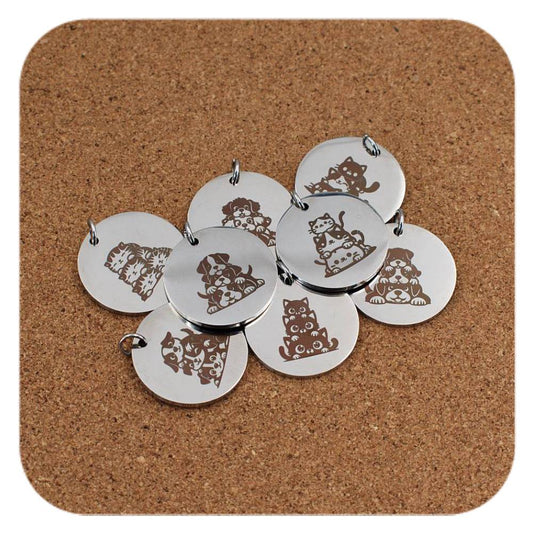 Silver pendants with different Cats Dogs Trio designs on cork background