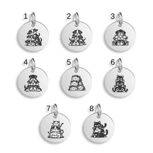 Silver pendants with different Cats Dogs Trio designs on a white background